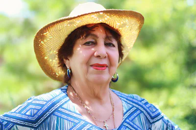 Senior woman in sunshine wearing hat