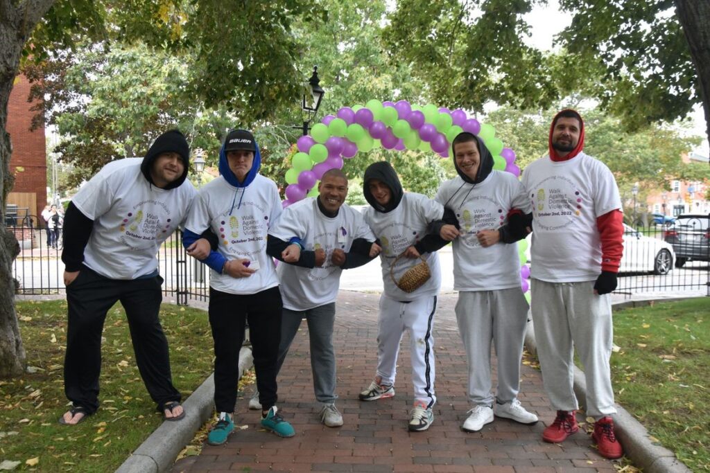 A team of walk participants lock arms to show support.