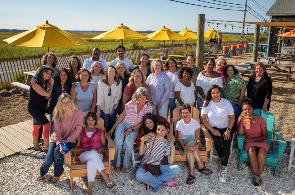 A group of smiling individuals posing outside